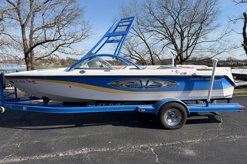 Slide: The Image of 2004 Nautique Super Air Nautique 210 boat on trailer, parked outdoors. - 9