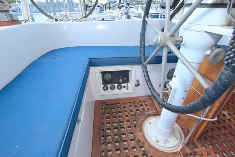 Slide: The Image of Cockpit of 1987 Morgan 43 CC sailboat with blue seating and steering wheel. - 26