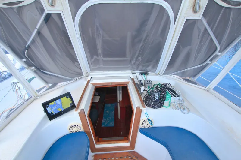 Slide: The Image of 1987 Morgan 43 CC yacht cockpit with navigation equipment and cabin entrance. - 28