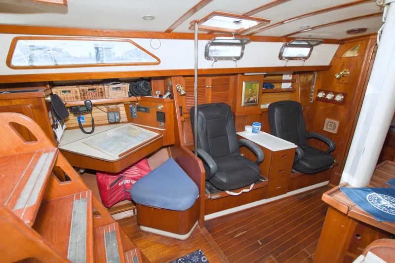 Slide: The Image of Interior of 1987 Morgan 43 CC sailboat with navigation station and seating area. - 29