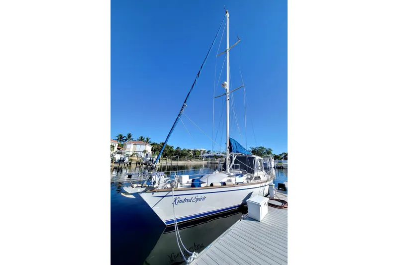 Slide: The Image of 1987 Morgan 43 CC sailboat docked in a sunny marina, clear blue sky. - 3
