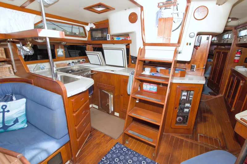 Slide: The Image of Interior of 1987 Morgan 43 CC sailboat with wooden cabinetry and cozy seating area. - 33