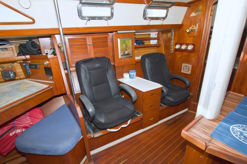 Slide: The Image of Interior of 1987 Morgan 43 CC yacht with wooden furnishings and seating area. - 39
