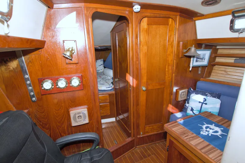 Slide: The Image of Interior of 1987 Morgan 43 CC sailboat with wooden furnishings and nautical decor. - 41