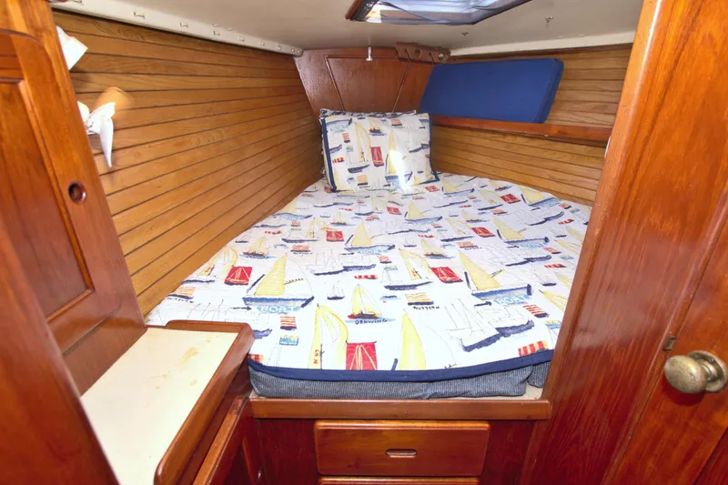 Slide: The Image of Cozy cabin interior of 1987 Morgan 43 CC sailboat with nautical-themed bedding. - 45
