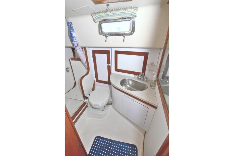 Slide: The Image of 1987 Morgan 43 CC yacht bathroom with sink, toilet, and shower area. - 58