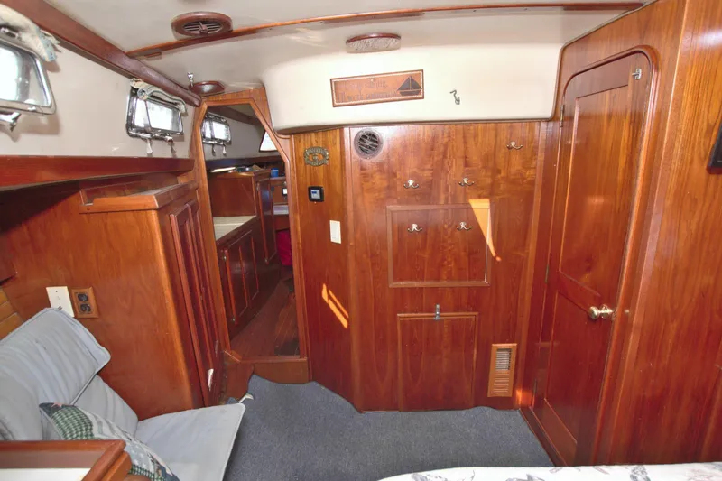 Slide: The Image of Interior of 1987 Morgan 43 CC sailboat with wooden cabinetry and cozy seating area. - 60