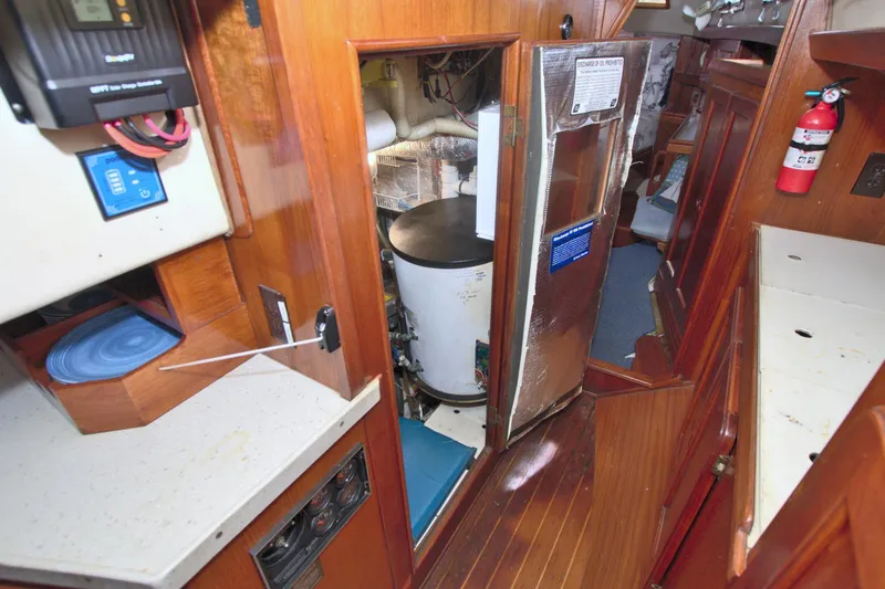 Slide: The Image of Interior of 1987 Morgan 43 CC sailboat showing equipment and wooden cabinetry. - 62