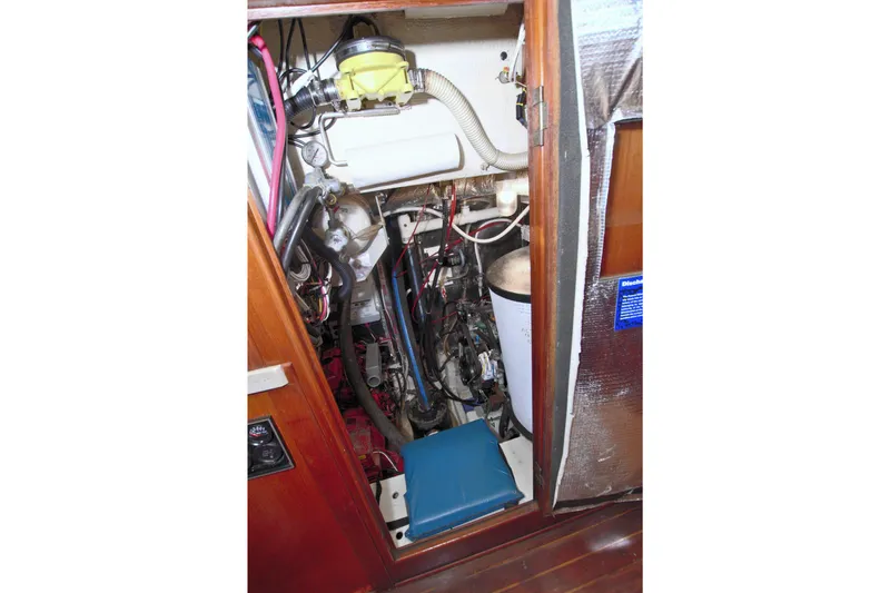 Slide: The Image of Engine compartment of a 1987 Morgan 43 CC sailboat, showcasing mechanical components. - 63