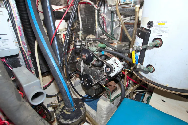 Slide: The Image of Engine room of a 1987 Morgan 43 CC sailboat, showcasing mechanical components and wiring. - 66