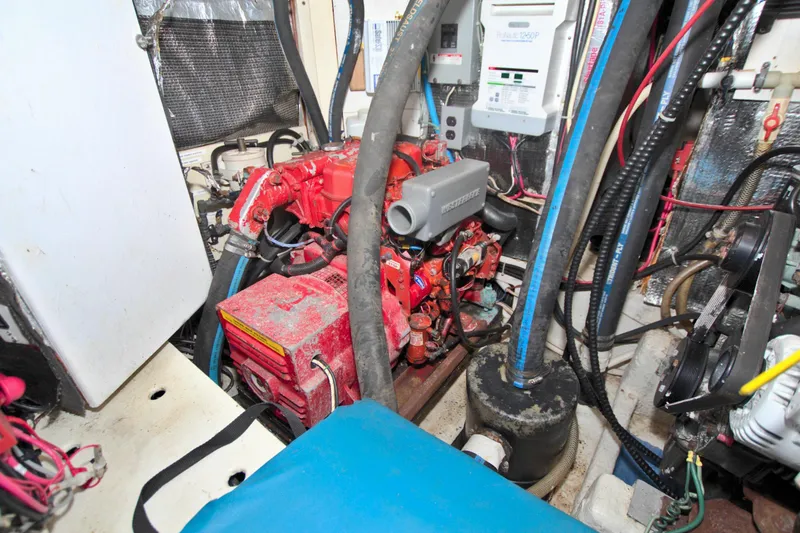 Slide: The Image of Engine room of a 1987 Morgan 43 CC sailboat, featuring a red engine and various components. - 68