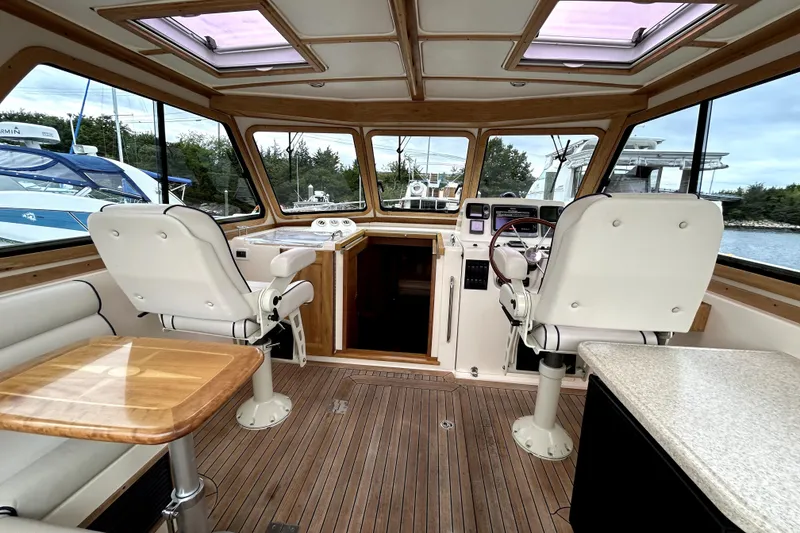 Slide: The Image of Interior of 2006 Sabre 38 Hard Top Express yacht with helm and seating area. - 10