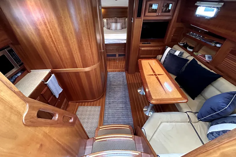 Slide: The Image of Luxurious interior of 2006 Sabre 38 Hard Top Express yacht with wood finishes and cozy seating. - 11
