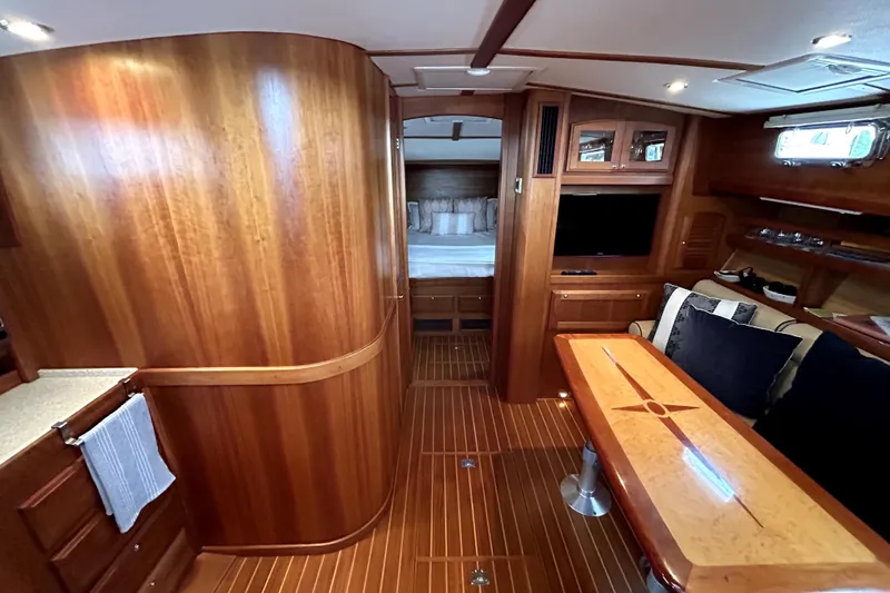 Slide: The Image of Luxurious interior of 2006 Sabre 38 Hard Top Express yacht with wood finishes and cozy seating. - 12
