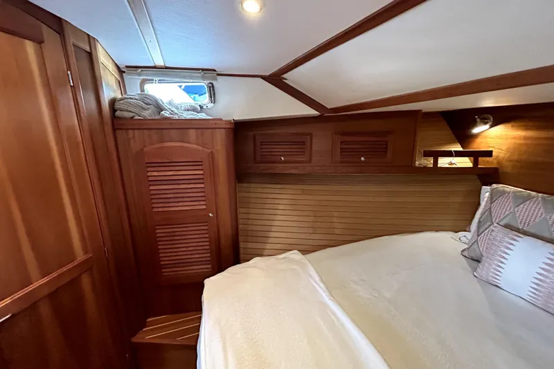 Slide: The Image of Cozy cabin interior of 2006 Sabre 38 Hard Top Express with wooden finishes and bedding. - 17