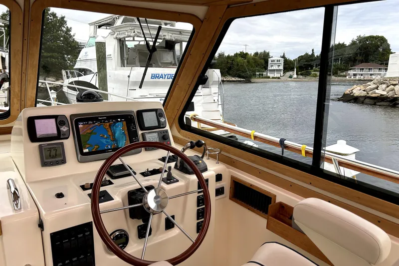 Slide: The Image of Interior view of 2006 Sabre 38 Hard Top Express boat cockpit with navigation equipment. - 4