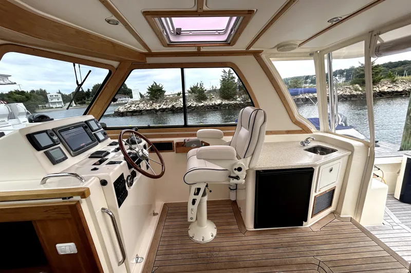 Slide: The Image of Interior of 2006 Sabre 38 Hard Top Express yacht with helm, seating, and kitchenette. - 6