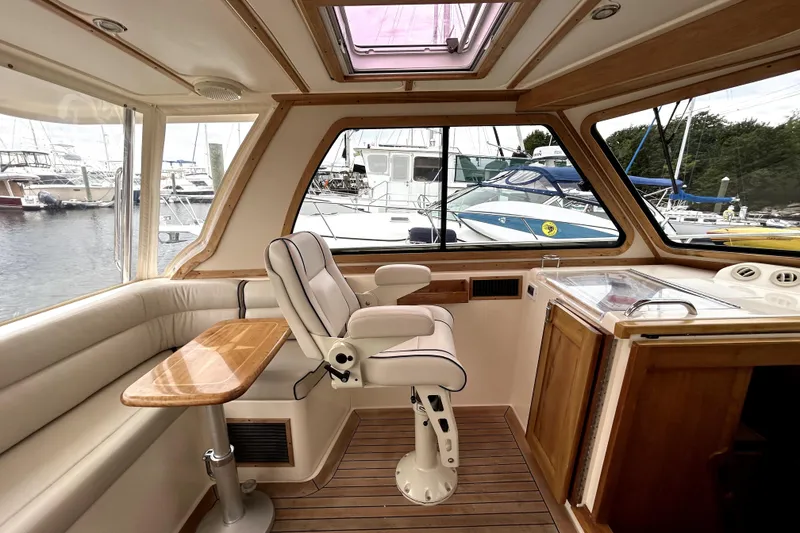 Slide: The Image of Interior of 2006 Sabre 38 Hard Top Express yacht with helm seat and wooden accents. - 8