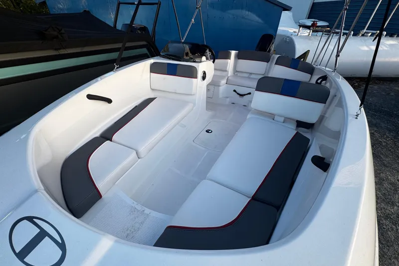 Slide: The Image of 2024 Tahoe T16 boat interior with white and gray seating, blue accents, and spacious layout. - 3