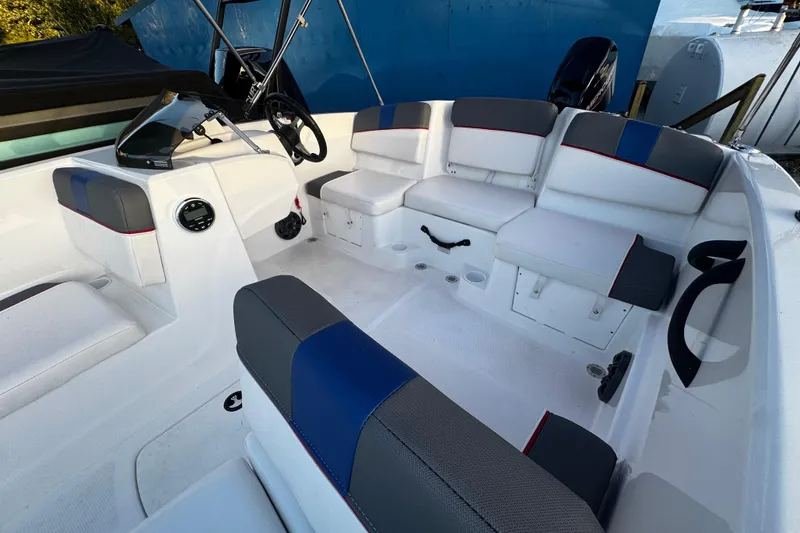 Slide: The Image of 2024 Tahoe T16 boat interior with white and gray seating, blue accents, and steering console. - 4