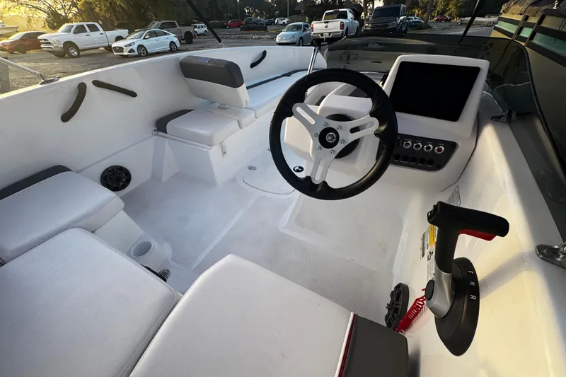 Slide: The Image of 2024 Tahoe T16 boat interior with steering wheel and seating area. - 5