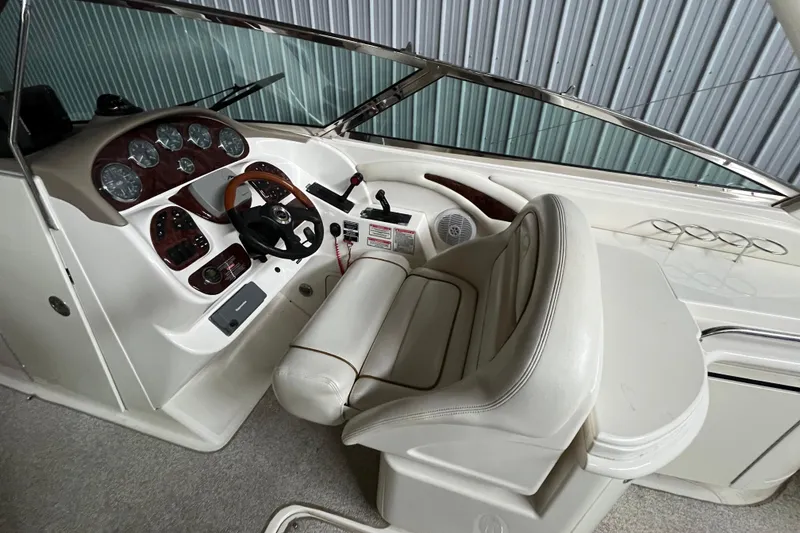 Slide: The Image of 2003 Sea Ray 290 Bowrider cockpit with steering wheel and instrument panel. - 14