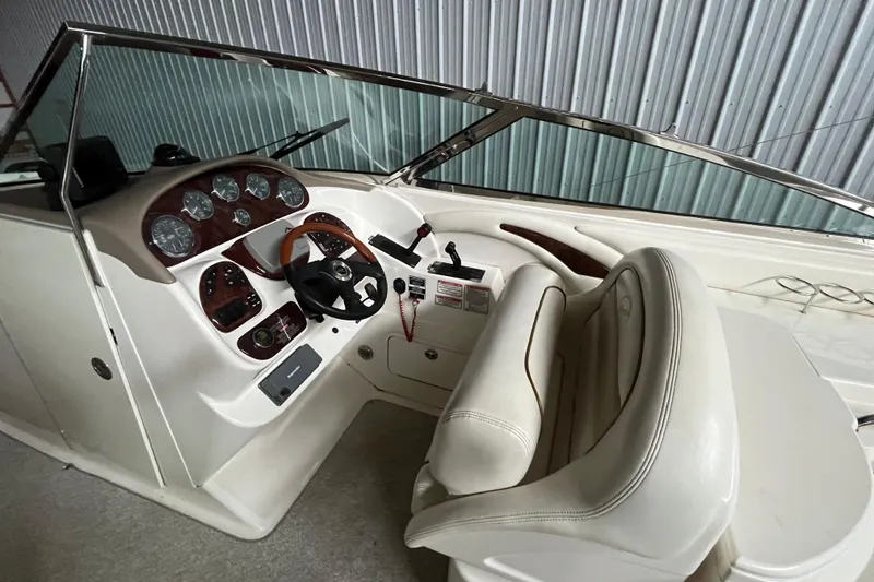 Slide: The Image of 2003 Sea Ray 290 Bowrider cockpit with steering wheel and instrument panel. - 15