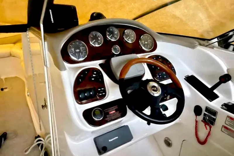 Slide: The Image of 2003 Sea Ray 290 Bowrider dashboard with steering wheel and instrument panel. - 17