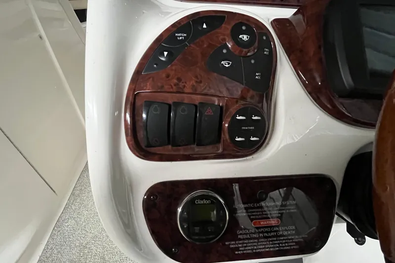 Slide: The Image of Control panel of a 2003 Sea Ray 290 Bowrider boat with various switches and buttons. - 18