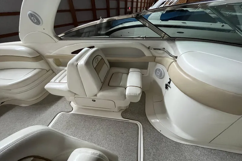Slide: The Image of Interior of a 2003 Sea Ray 290 Bowrider boat with white and beige seating. - 20
