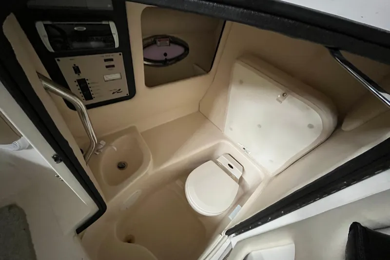 Slide: The Image of 2003 Sea Ray 290 Bowrider boat bathroom interior with toilet and sink. - 21