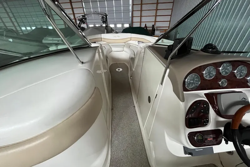 Slide: The Image of 2003 Sea Ray 290 Bowrider interior with dashboard and seating area. - 22