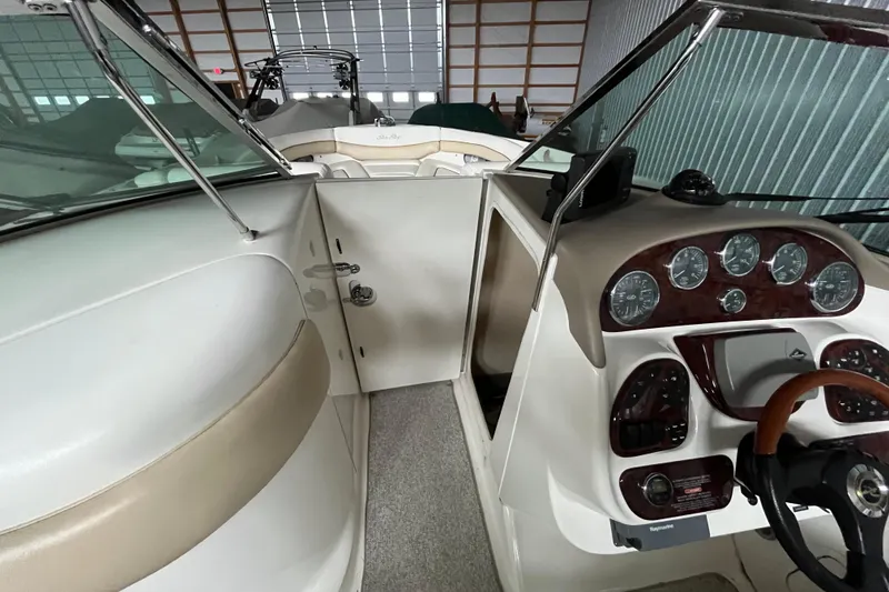 Slide: The Image of 2003 Sea Ray 290 Bowrider cockpit with steering wheel and instrument panel in storage. - 23
