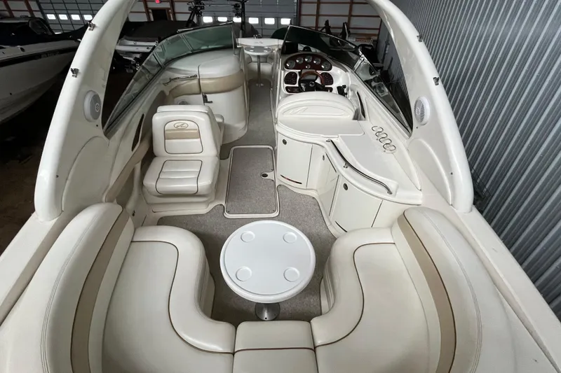 Slide: The Image of 2003 Sea Ray 290 Bowrider interior with beige seating and sleek dashboard design. - 29