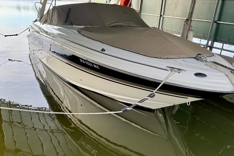 Slide: The Image of 2003 Sea Ray 290 Bowrider boat docked with cover in marina. - 3