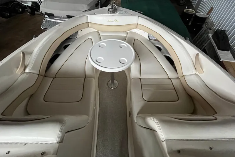Slide: The Image of 2003 Sea Ray 290 Bowrider interior with white seating and round table. - 30