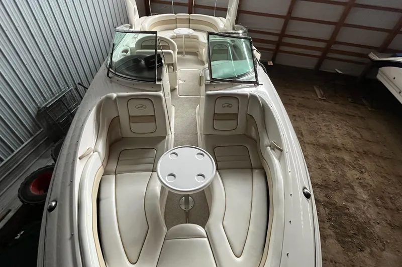 Slide: The Image of 2003 Sea Ray 290 Bowrider boat with spacious seating and table in storage. - 31