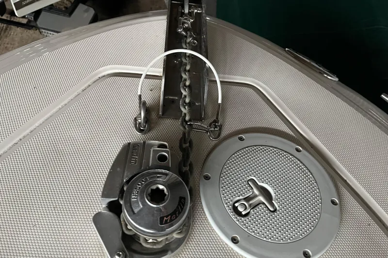 Slide: The Image of Anchor chain mechanism on a 2003 Sea Ray 290 Bowrider boat deck. - 32