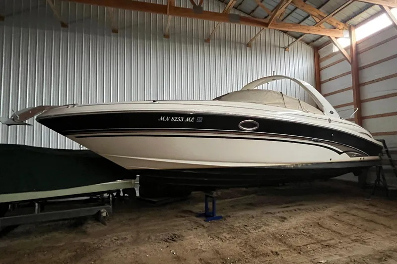 Slide: The Image of 2003 Sea Ray 290 Bowrider boat stored indoors on a trailer. - 35
