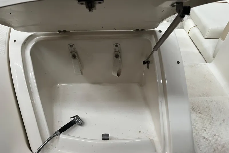 Slide: The Image of Open storage compartment on a 2003 Sea Ray 290 Bowrider boat. - 8