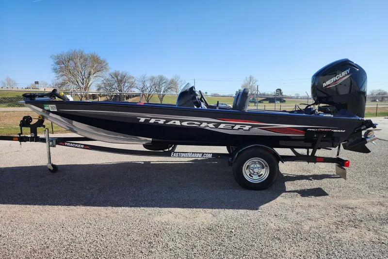 Slide: The Image of 2022 Tracker Pro Team 175 boat on trailer, parked outdoors under clear sky. - 5