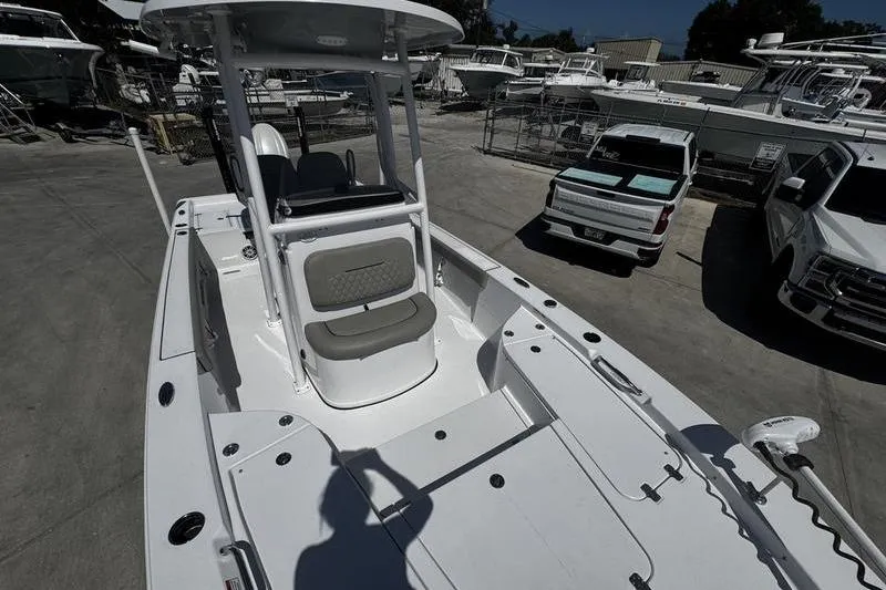 Slide: The Image of 2024 SPORTMAN MASTERS 227 boat in a marina, surrounded by vehicles and other boats. - 10
