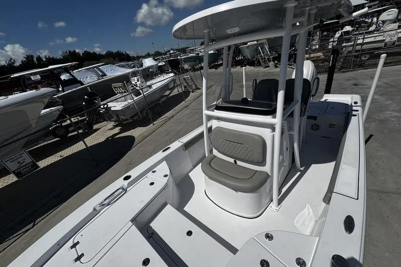 Slide: The Image of 2024 SPORTMAN MASTERS 227 boat at a marina, showcasing sleek design and seating area. - 11
