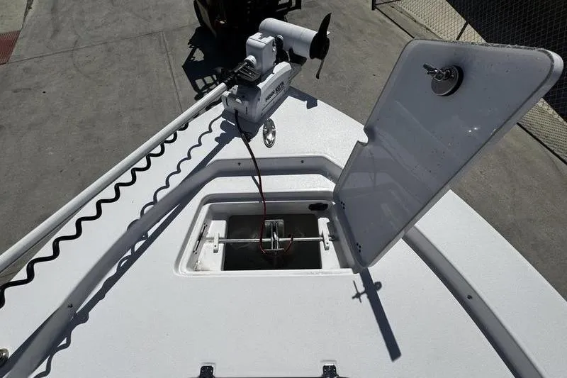 Slide: The Image of 2024 SPORTMAN MASTERS 227 boat deck with open hatch and trolling motor. - 12