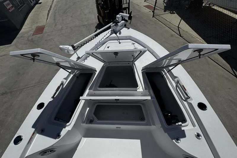 Slide: The Image of 2024 SPORTMAN MASTERS 227 boat with open storage compartments on deck. - 13