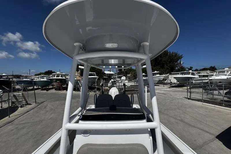 Slide: The Image of 2024 SPORTMAN MASTERS 227 boat in a marina, surrounded by other vessels. - 15