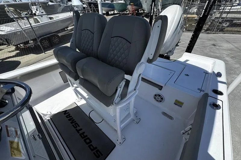Slide: The Image of 2024 SPORTMAN MASTERS 227 boat interior with dual seats and steering wheel. - 19