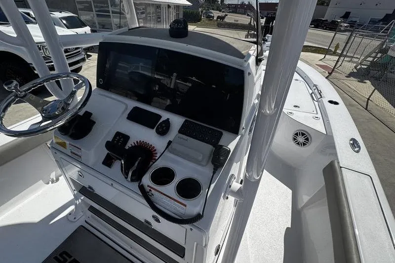 Slide: The Image of 2024 SPORTMAN MASTERS 227 boat console with steering wheel and controls. - 22