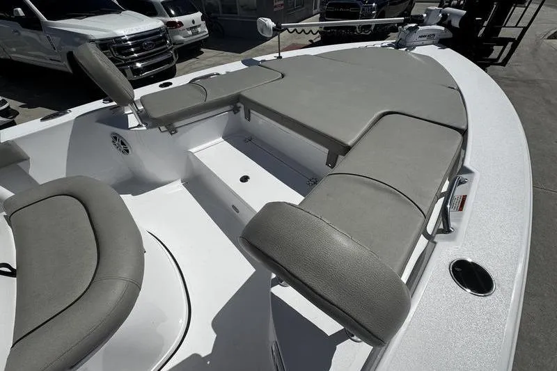 Slide: The Image of 2024 SPORTMAN MASTERS 227 boat interior with gray cushioned seating and storage compartments. - 26
