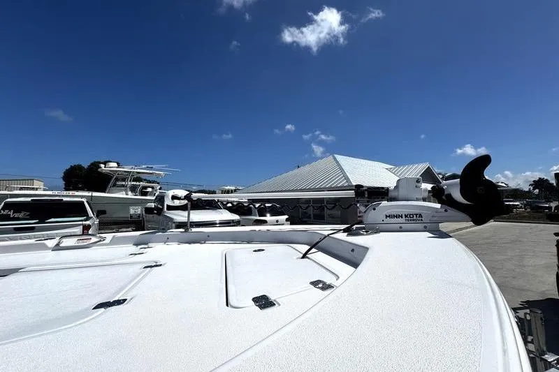 Slide: The Image of 2024 SPORTMAN MASTERS 227 boat with Minn Kota trolling motor under clear blue sky. - 4